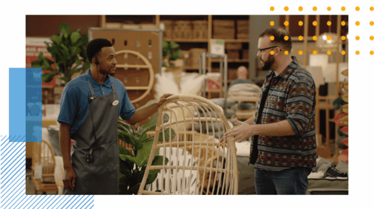 an employee is helping a customer with a question about lawn furniture